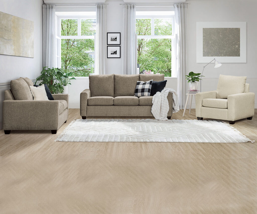 Upholstered living room furniture set with sofa, loveseat, and chair in bright room.