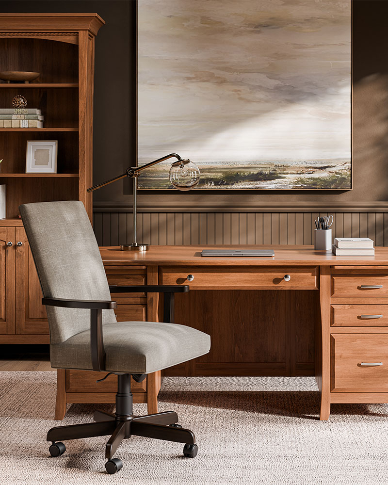 Solid wood executive office desk with upholstered swivel chair and matching bookcase