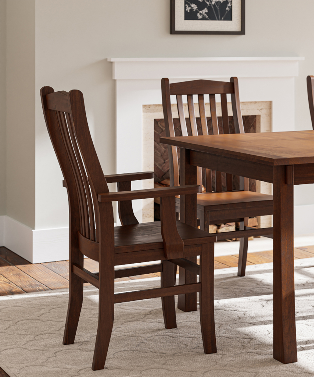 Solid wood dining chair furniture with matching table near a fireplace.